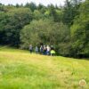 People walking across a field in North Wales